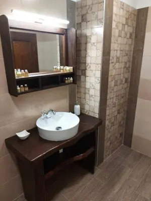 a bathroom with a sink and a mirror at Кондеви къщи in Kovachevitsa