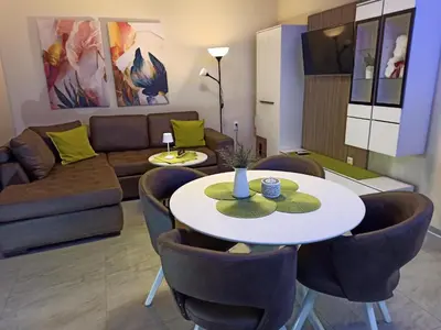 a living room with a couch and a table and chairs at Azalia Sandanski in Sandanski