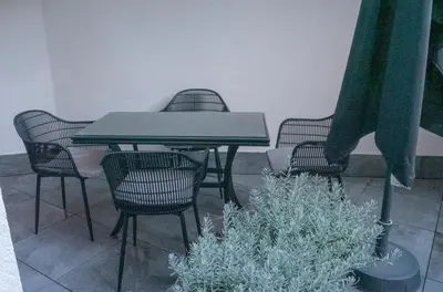 a table and chairs with a table and some plants at Луксозно студио One Place in Sofia A1 - Лозенец in Sofia