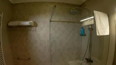 a bathroom with a shower with a glass door at Луксозно студио One Place in Sofia A1 - Лозенец in Sofia