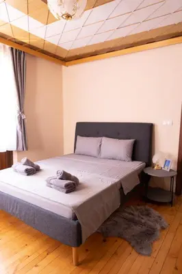 a bedroom with a bed with towels on it at Guesthouse Gaby in Sapareva Banya
