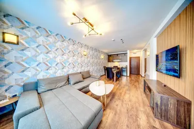a living room with a couch and a table at Oak Residence Hotel & Relax in Smolyan