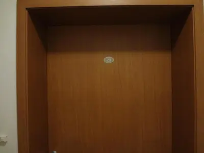 a wooden door with a sign on it at Deluxe Apartments in Pamporovo