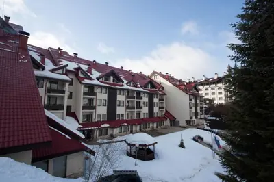 a group of buildings with snow on the ground at Deluxe Apartments in Pamporovo