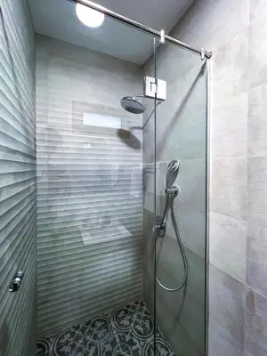 a shower with a glass door in a bathroom at Deluxe Central Rooms in Karlovo