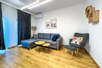 a living room with a couch and a table at Deluxe Central Rooms in Karlovo