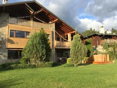 a house with a deck and a yard at Villa Chalet Everest in Bansko