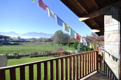 a balcony with a view of a field and mountains at Villa Chalet Everest in Bansko
