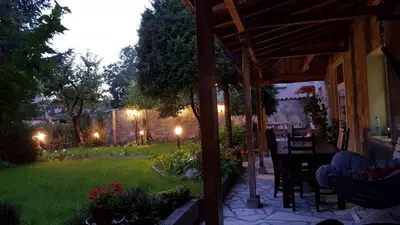a backyard at night with a pergola at villa Tia Maria in Hisarya
