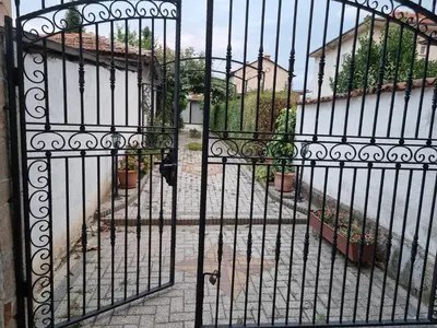 an iron gate with a courtyard behind it at villa Tia Maria in Hisarya