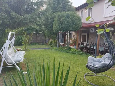 two chairs sitting in a yard next to a house at villa Tia Maria in Hisarya