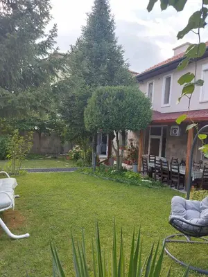a yard with chairs and a house at villa Tia Maria in Hisarya