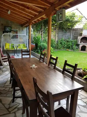 a wooden table and chairs on a patio at villa Tia Maria in Hisarya