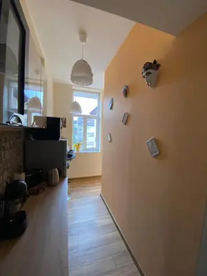 a living room with a wall with pictures on it at Cozy apartment in downtown Sofia - Tsar Samuil Street in Sofia