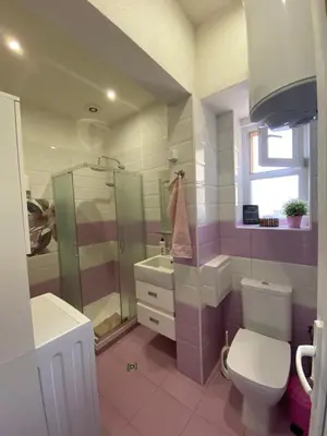 a bathroom with a shower and a toilet and a sink at Cozy apartment in downtown Sofia - Tsar Samuil Street in Sofia