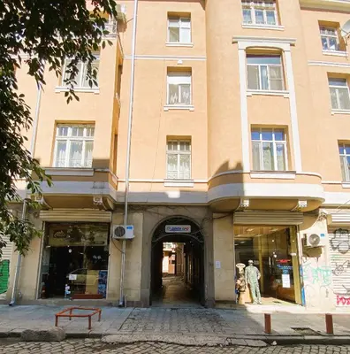 a building on a street with people in the doorway at Cozy apartment in downtown Sofia - Tsar Samuil Street in Sofia