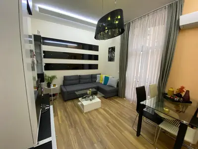 a living room with a couch and a table at Cozy apartment in downtown Sofia - Tsar Samuil Street in Sofia