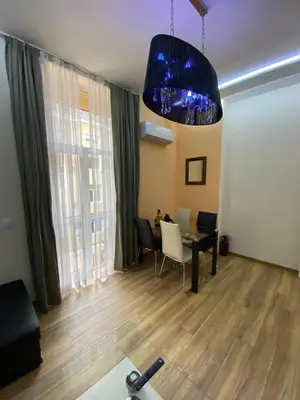 a living room with a table and a blue light at Cozy apartment in downtown Sofia - Tsar Samuil Street in Sofia