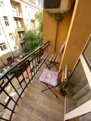 a balcony with a table and a chair on it at Cozy apartment in downtown Sofia - Tsar Samuil Street in Sofia