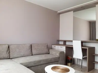 a living room with a couch and a table at ВИЛА Belle Vie in Beli Iskar