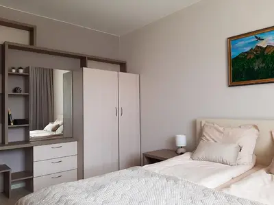 a white bedroom with a bed and a mirror at ВИЛА Belle Vie in Beli Iskar