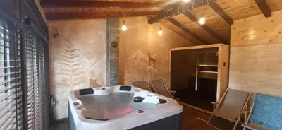 a bath tub in a room with chairs in it at ВИЛА Belle Vie in Beli Iskar