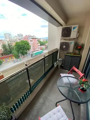 a balcony with a table and a view of a street at Modern & Central 1BR Apartment with lovely terrace in Plovdiv