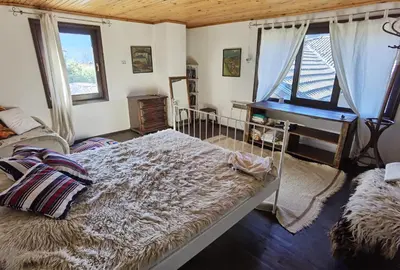 a bedroom with a bed and a desk and a piano at Room for guests in Smolyan