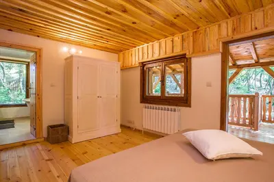 a bedroom with a bed and a wooden ceiling at Garmen Hills Guest Houses in Garmen