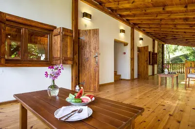 a room with a wooden table with a bowl of fruit on it at Garmen Hills Guest Houses in Garmen