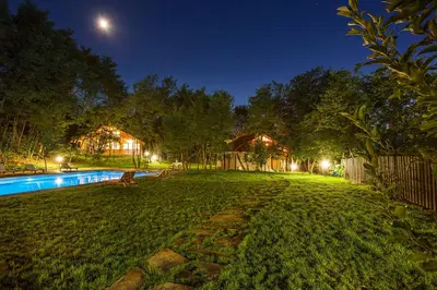 a backyard at night with a swimming pool at Garmen Hills Guest Houses in Garmen