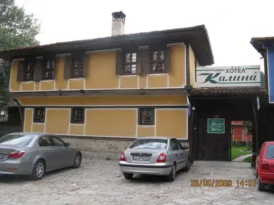 two cars parked in front of a building at Family Hotel Kalina in Koprivshtitsa
