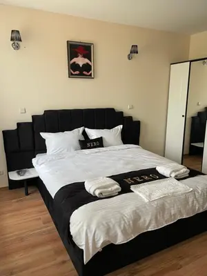 a bedroom with a large bed with two towels on it at Complex Nero in Pamporovo