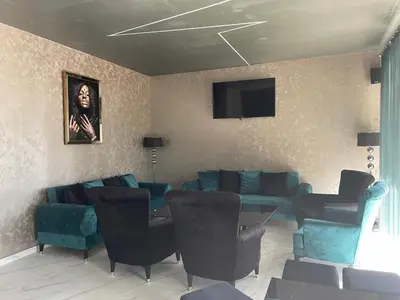 a living room with blue couches and a tv at Complex Nero in Pamporovo