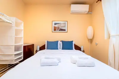 a bedroom with a large white bed with blue pillows at The Cozy Home 1-Bedroom in Central Plovdiv by Flat Mаnager in Plovdiv