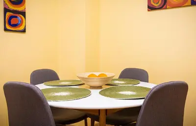 a table with four chairs and a bowl on it at The Cozy Home 1-Bedroom in Central Plovdiv by Flat Mаnager in Plovdiv