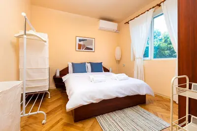 a bedroom with a large bed and a window at The Cozy Home 1-Bedroom in Central Plovdiv by Flat Mаnager in Plovdiv
