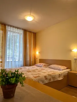 a bedroom with a large bed and a window at Castle Romance - Pamporovo in Pamporovo
