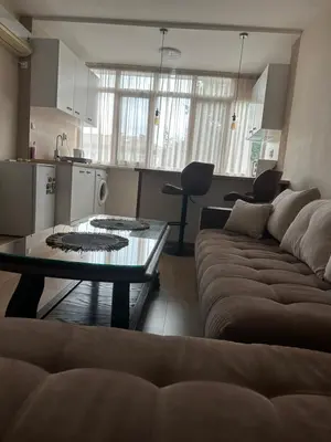 a living room with a couch and a table at Rose in Karlovo
