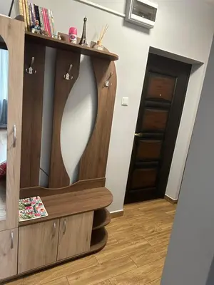 a dressing room with a mirror in a wooden cabinet at Rose in Karlovo