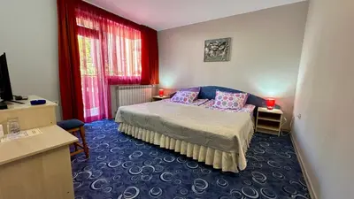a bedroom with a bed with two pillows on it at Kaloyanova House Bansko in Bansko