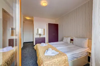 a hotel room with a bed with towels on it at Colorful 2BD Apartment with Indoor Fireplace and Mountain View by Flat Mаnager in Pamporovo