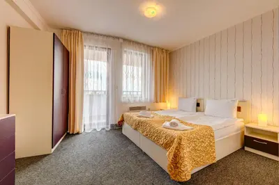a hotel room with a bed and a window at Colorful 2BD Apartment with Indoor Fireplace and Mountain View by Flat Mаnager in Pamporovo