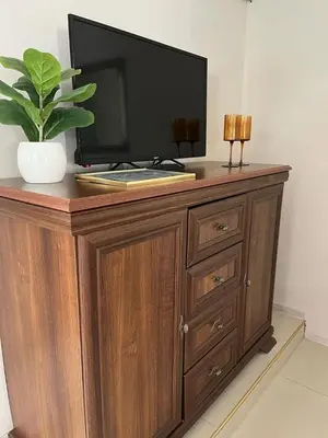 a wooden entertainment center with a television on top of it at Белият кът in Sapareva Banya
