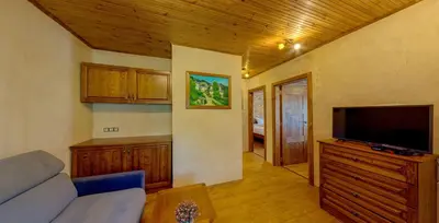 a living room with a couch and a flat screen tv at Къща за гости 