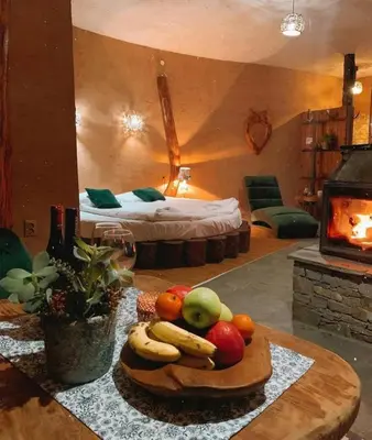 a room with a tray of fruit on a table at Панорама хаус Лещен и еко къщи Дървена и Землянка in Leshten