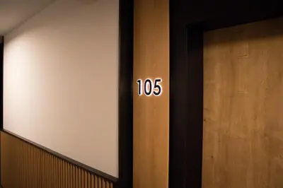 a door with the number on it next to a wooden door at EMAR HOTEL & SPA in Sapareva Banya