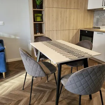 a white table and chairs in a kitchen at New luxury apartment next to subway with garage in Sofia