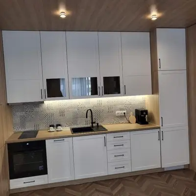 a kitchen with white cabinets and a sink at New luxury apartment next to subway with garage in Sofia