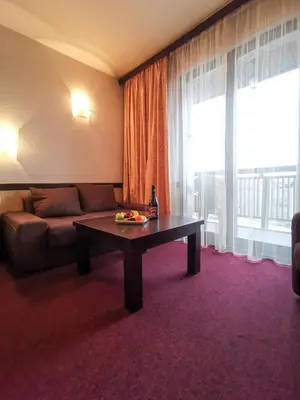 a living room with a couch and a table at Trinity Residence Bansko with Free Shuttle to Gondola in Bansko
